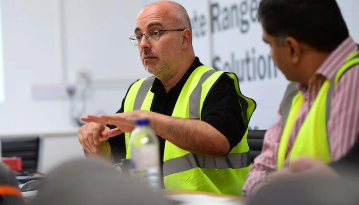 group of people sat around a table receiving training